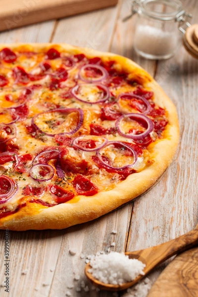 Fototapeta Closeup on hunter's sausage pizza on the wooden rustic table