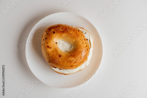 Fototapeta Bagels. Bagels with Lox and Cream Cheese. Fresh made bagels with a variety of different cream cheeses and spreads. Traditional classic New York breakfast menu item. 