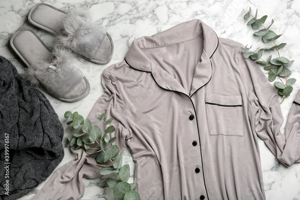 Obraz Fluffy slippers, pajamas and knitted blanket on white marble background, flat lay. Comfortable home outfit