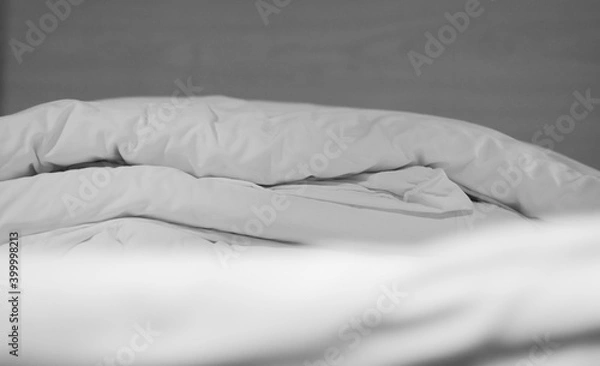 Obraz Soft and calm atmosphere image of all white bed room. Pillows and blanket on empty bed, close up.