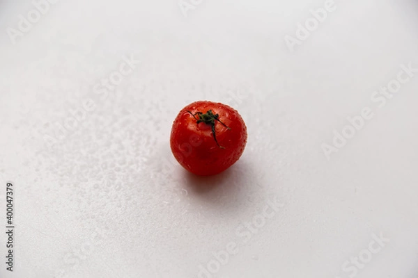 Obraz Cherry tomato covered with splashing water. White background. Isolate.