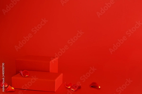 Fototapeta Two red rectangular podiums of different heights and rose flower petals on red background