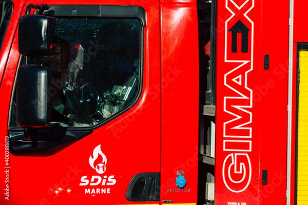 Obraz View of a red French fire engine in intervention in front of the Reims cathedral during the coronavirus pandemic affecting France and the lockdown of the country
