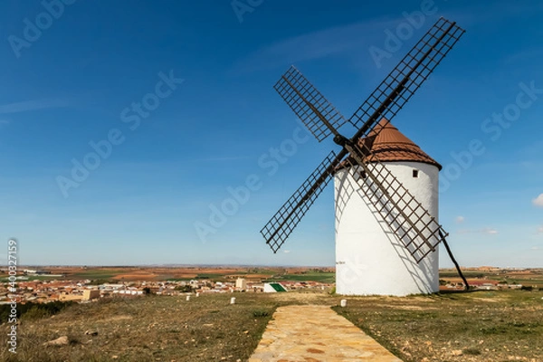 Obraz Ancient stone windmills in La Mancha. Blue sky with clouds.
