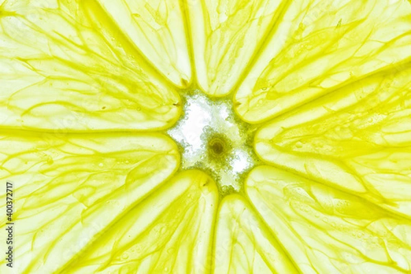 Fototapeta Close-up of a yellow lemon slice isolated on a white background.