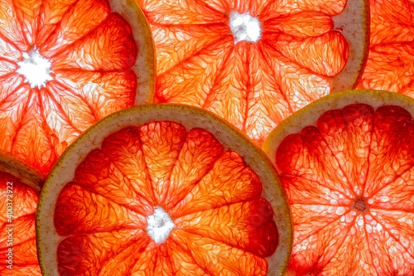 Fototapeta Pink grapefruit slices isolated on a white background.