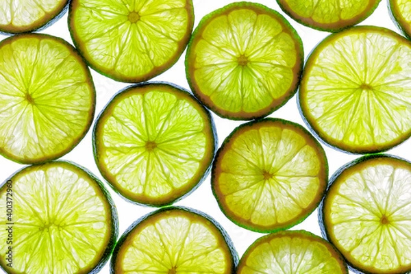 Fototapeta Green lime slices isolated on a white background.