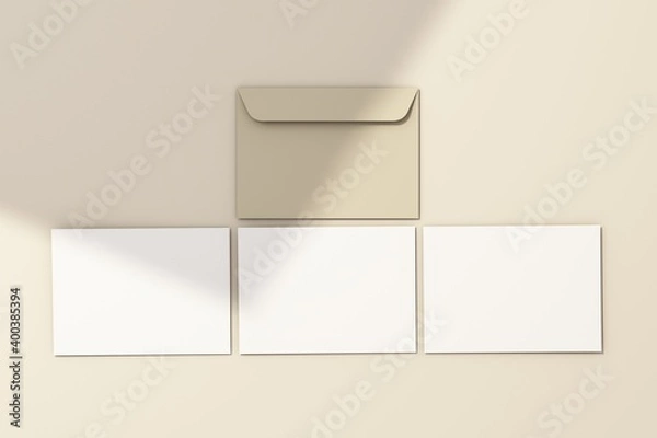 Fototapeta Blank white 5x7 card on white floor with rays of sunlight 