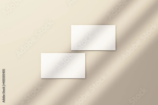 Fototapeta Blank white business card on white floor with rays of sunlight 