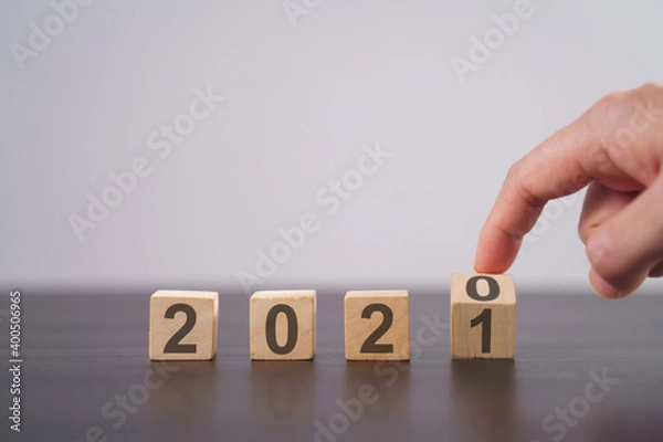 Fototapeta Text 2021 on wooden cube isolated over background.