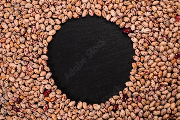 Obraz Coloren beans on black stone background.