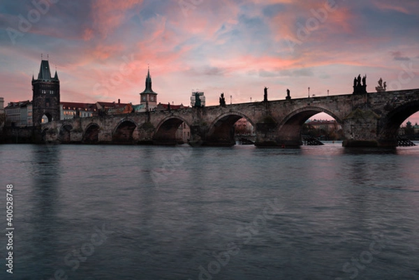 Fototapeta Charles Bridge on the Vltava River at sunset and colorful clouds
