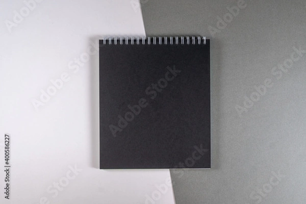 Fototapeta centered black notebook on white gray background
