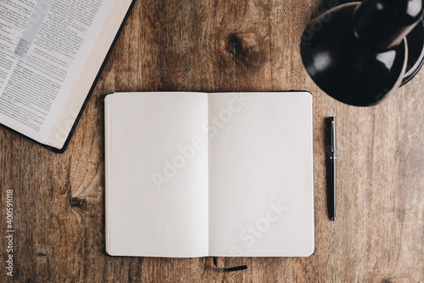 Fototapeta Blank notebook for bible study on a wooden desk. Top view flat lay.