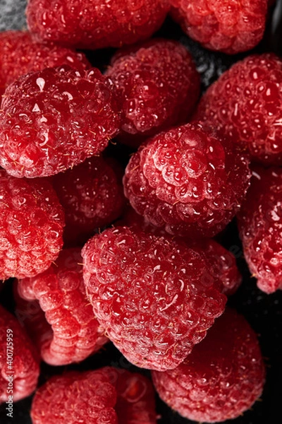 Fototapeta Close up of fresh and juicy raspberries filling the frame.