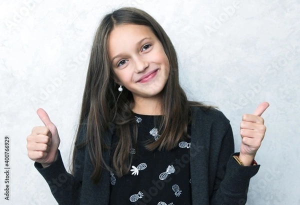 Obraz Smiling pretty girl showing thumbs up