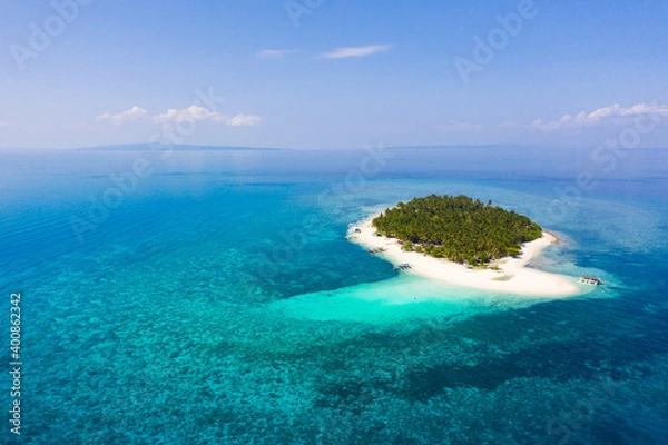 Fototapeta Island with a tropical beach and turquoise lagoons. Tropical island on a coral reef, top view.