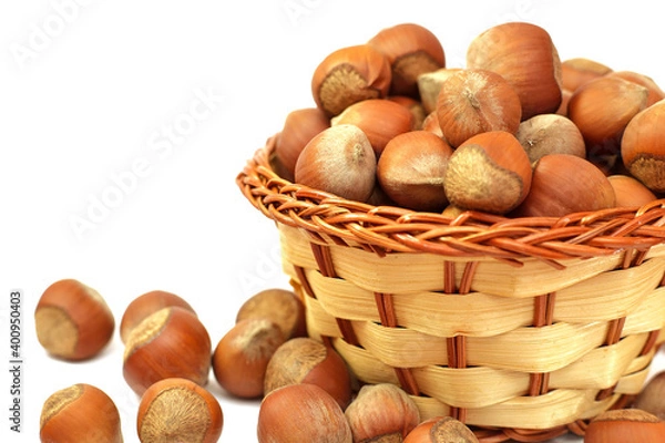 Obraz hazelnut in wicker basket isolated on white background.