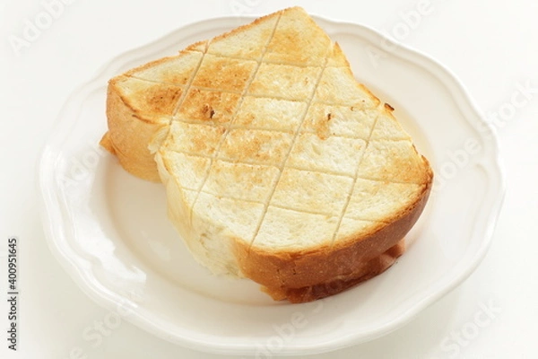 Fototapeta Toasted bread with cut pattern on dish