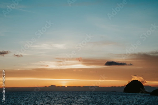 Obraz Sunset view with ocean and Mantou rock at Lanyu island. The combination of blue and orange sky.