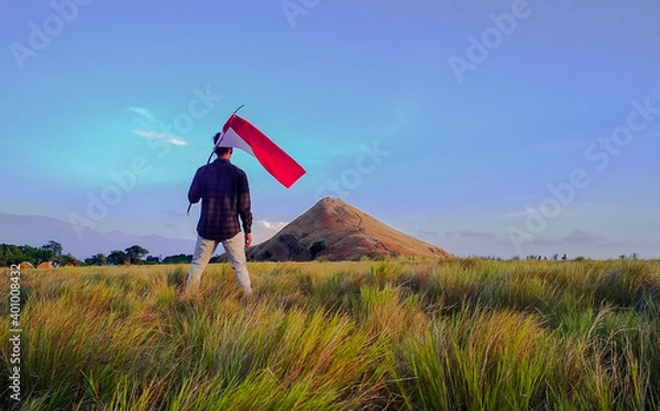 Fototapeta a man carrying the Indonesian flag