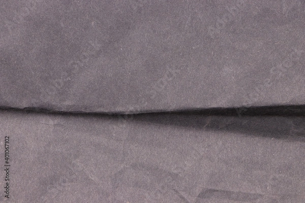 Fototapeta Black, crumpled aged paper in the middle. Empty background and texture.