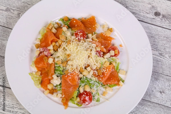 Fototapeta Caesar salad with salmon and parmesan