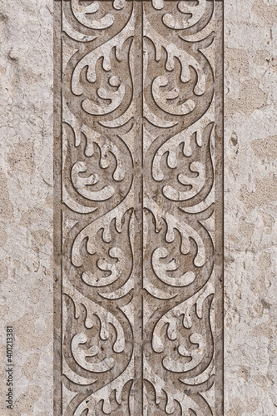 Fototapeta Ornamental print on the granite surface. Vintage ornament on the stone. Embossed drawing. Close-up. Stone texture. Pattern on the stone. Embossed pattern. Wallpaper. Tile. Close-up of seamless texture