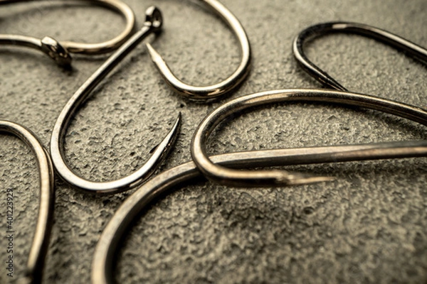 Obraz Fishing hooks on concrete textured background macro