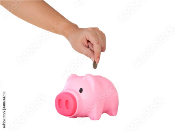 Obraz Hand putting coin into pink piggy bank isolated on white background. Selective focus. Savings for education, travelling, retirement, hospitalization concept.