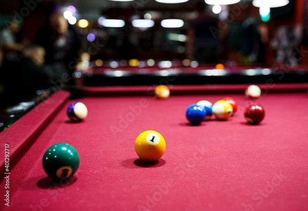 Fototapeta group of snooker multicolored balls lays on the table. Closeup view. Billiard red table with cue and balls. Leisure, hobby and entertainment concept