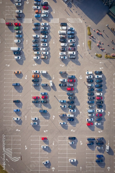 Fototapeta Rows on the cars on a large parking lot near the supermarket - the end of the quarantine concept. Parking near a supermarket. Drone overhead top view magazine format shot. 