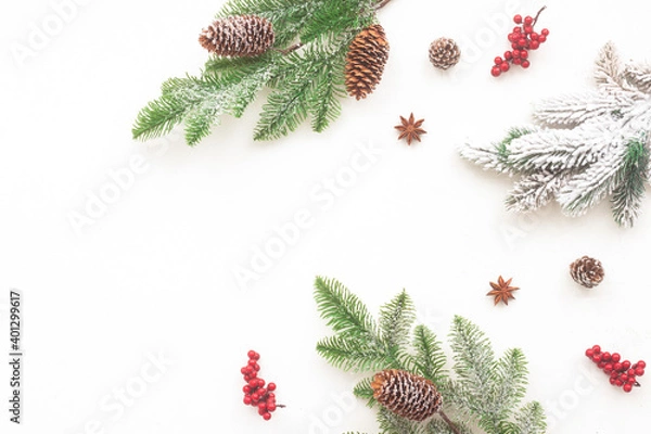 Obraz Christmas tree branches, red berries on white background, flat lay, top view