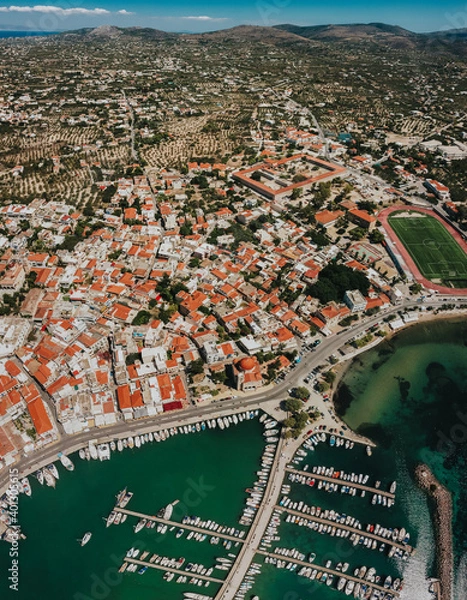Fototapeta Aerial View of Port Aegina With Luxury Yachts and sailing boats parking on shore.Cityscape wide view over Aegina Island.