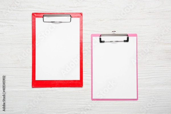 Fototapeta Clipboards with blank paper sheets on wooden background