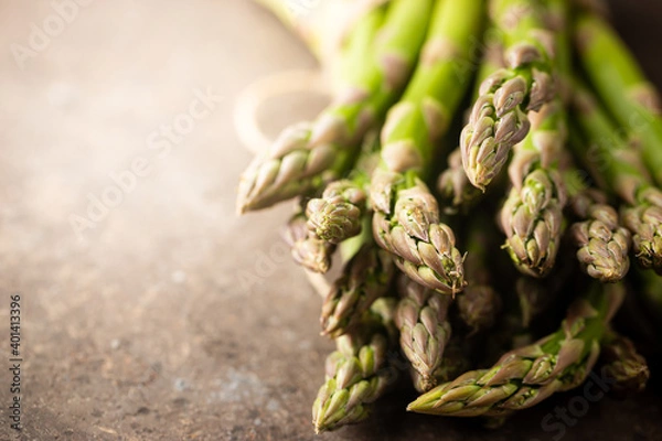 Fototapeta Bunch of fresh green asparagus spears on a rustic background
