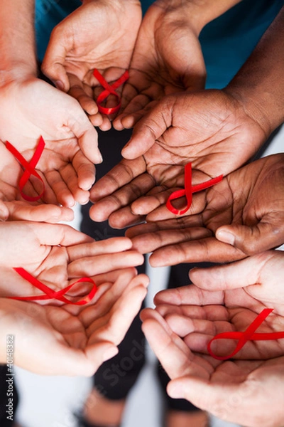 Obraz multiracial people holding red ribbon for AIDS HIV awareness