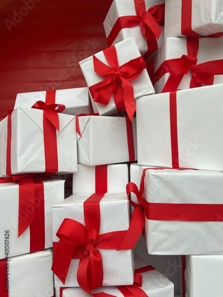 Obraz 
Gift boxes wrapped in white paper and red ribbon