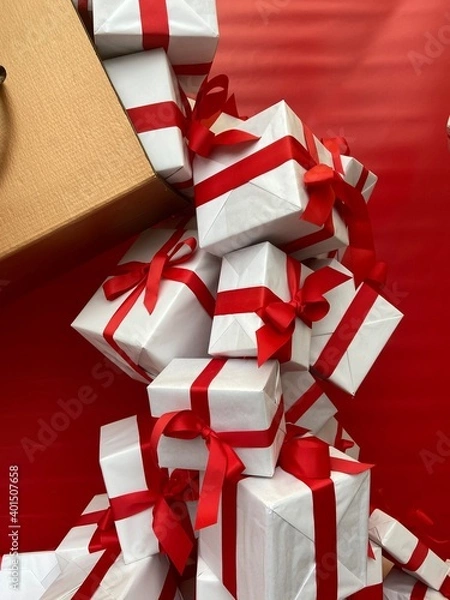 Obraz 
Gift boxes wrapped in white paper and red ribbon