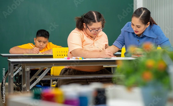 Obraz Asian Autism children with disability kid on wheelchair in special classroom with teacher. 
