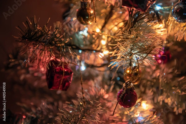 Obraz Festive lights of a Christmas tree, colorful balls on the branches