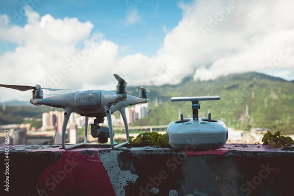 Fototapeta White drone with remote controller outdoors