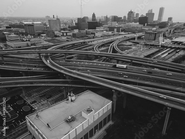 Fototapeta aerial view of freeway interchange with traffic and view of the city