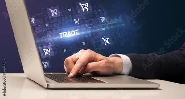 Fototapeta Businessman working on laptop with TRADE inscription, online shopping concept
