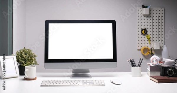 Obraz Front view of a computer with blank screen and equipment on designer or photographer workspace. Blank screen monitor for graphic display montage.