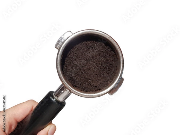 Obraz Close up wet coffee grounds in portafilter in barista hand isolated on white background.