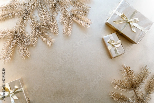 Fototapeta Golden Christmas or new year's background,plain composition of golden Christmas gifts and golden fir branches,Flatlay,empty space for greeting text.christmas concept.