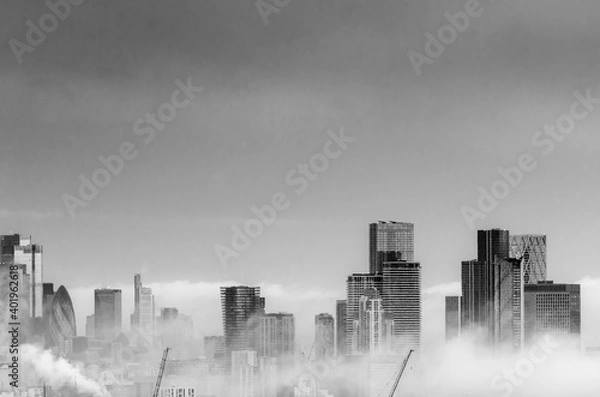 Obraz Clouds rising at the Canary Wharf skyscrapers and London skyline