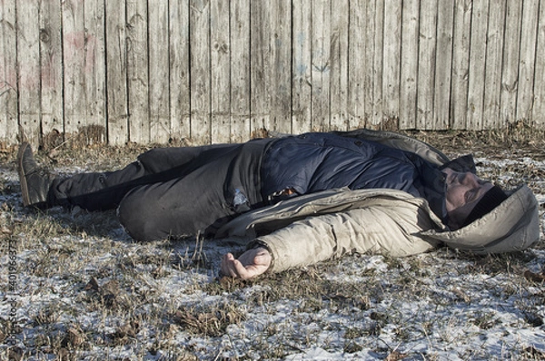 Obraz Murder. The body of a man lies on the melting snow. Brutal crime.