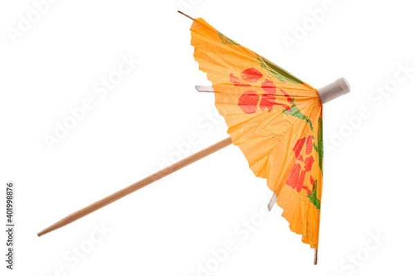 Fototapeta Summer party and drinking glass decoration concept with picture of colourful orange cocktail paper decorative umbrella isolated on white background with clipping path cutout